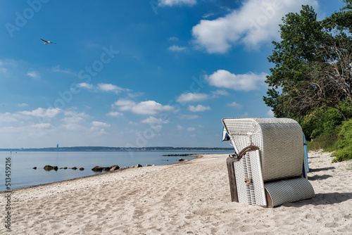Fototapeta Naklejka Na Ścianę i Meble -  traditional canopied beach chair on beautiful baltic sea beach on sunny day