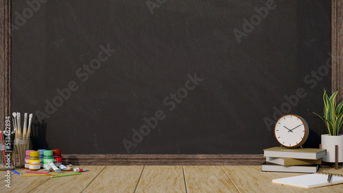 Photographie Creative study workspace with painting tools and copy space on wooden table over black board wall
