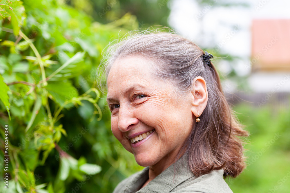  Beautiful elderly woman poses on a summer day.
