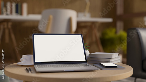 Portable workspace with portable notebook and decor on coffee table over blurred office desk