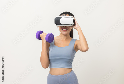 Training with dumbbell on virtual sport with isolated white background. Asian sport woman wearing sportswear workout with simulated world. Into the  future digital cyber universe. Future technology