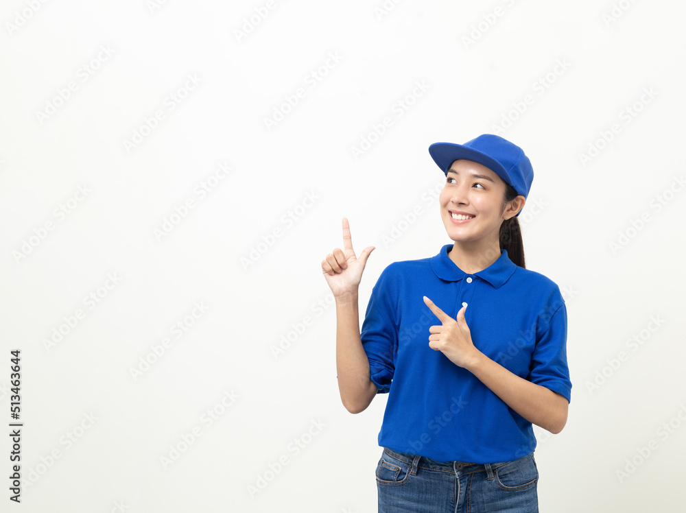 Happy delivery asian woman in blue uniform standing pointing the finger to blank space for text advertise on isolated white background. Smiling female delivery service worker. Happy delivery asian woman in blue uniform standing pointing the finger to blank space for text advertise on isolated white background. Smiling female delivery service worker.