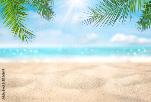 Fototapeta Naklejka Na Ścianę i Meble -  Summer vacation or holiday background. Tropical beach with sand, sea and coconut palm leaves. Can be used as background for product montage