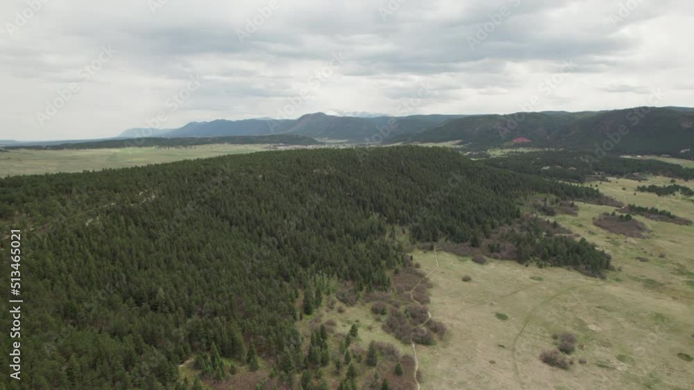 Aerial rise over forested ridge revealing beautiful valley, Rocky Mountain range. Aerial rise over forested ridge revealing beautiful valley, Rocky Mountain range.