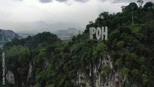 Aerial panning shot around the sign of Ipoh on top of limestone hill at Kawasan Perindustrian Tasek, Perak state, Malaysia, southeast Asia. photo