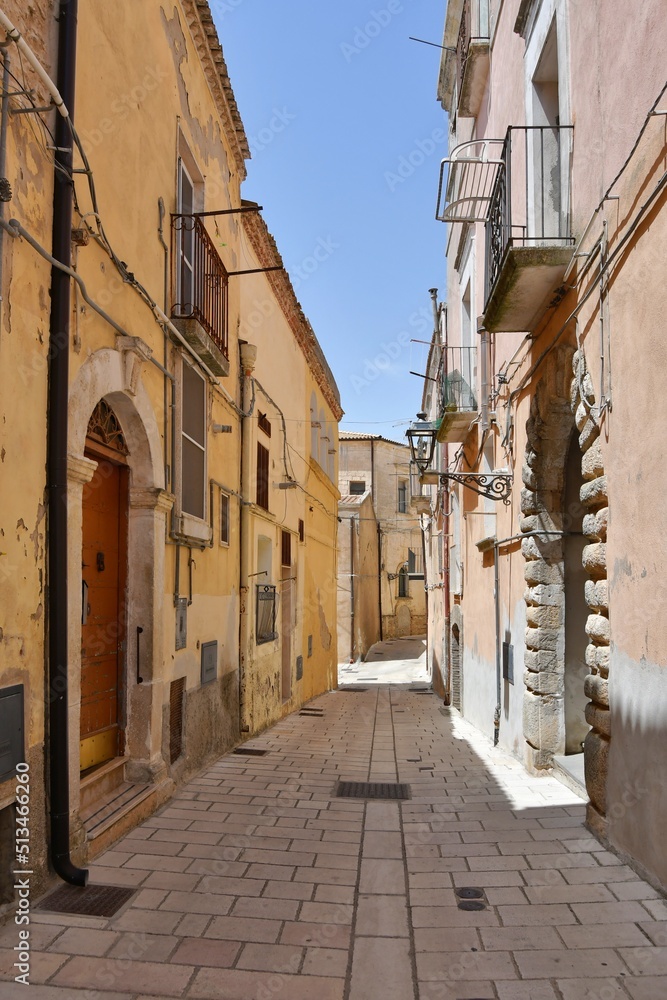 A narrow street among the old houses of Irsina in Basilicata, region of southern Italy.