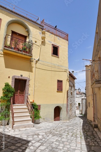 A narrow street among the old houses of Irsina in Basilicata, region of southern Italy. © Giambattista