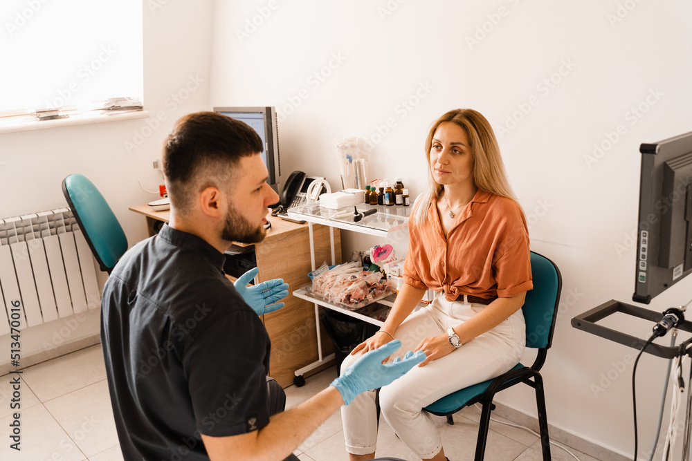 Obraz premium Visiting ENT doctor for examination of the state of health of the ear, throat and nose. Consultation of woman with otolaryngologist in a medical clinic.
