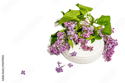 Lilac flowers bouquet on trendy stand isolated on a white background. Springtime concept