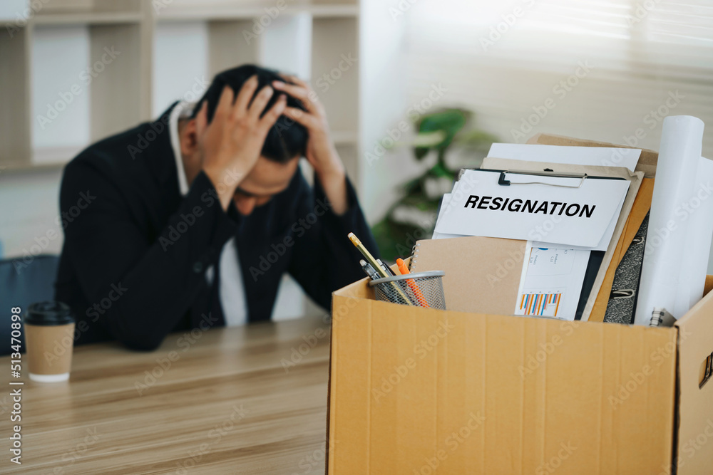 personal belongings and files into a brown cardboard box and ...