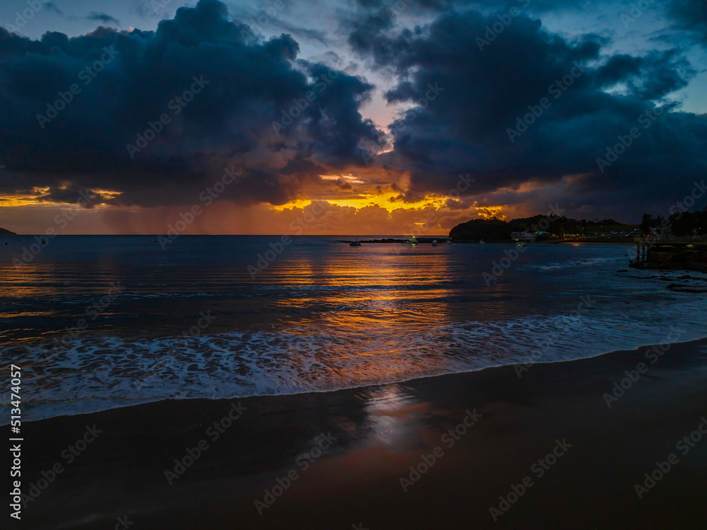Obraz premium Aerial sunrise at the seaside with rain clouds