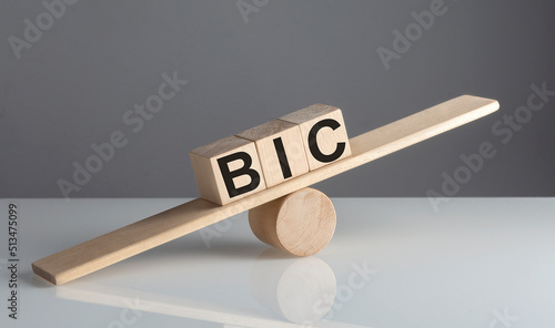 BIC Bank Identifier Code on wooden cubes on a wooden balance , business concept photo
