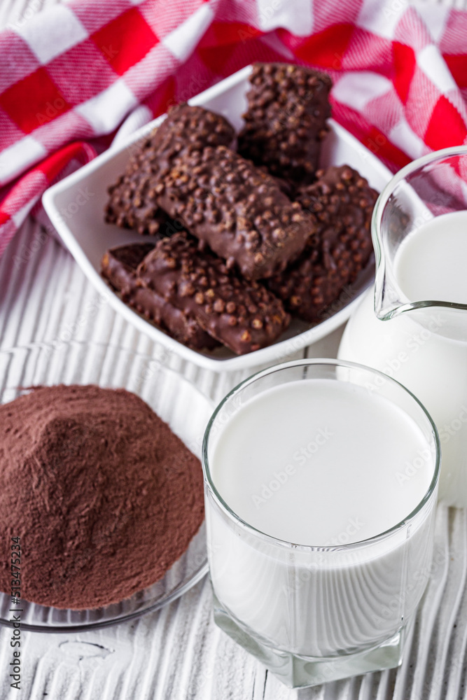 chocolate cocoa milk powder on a white wooden rustic background