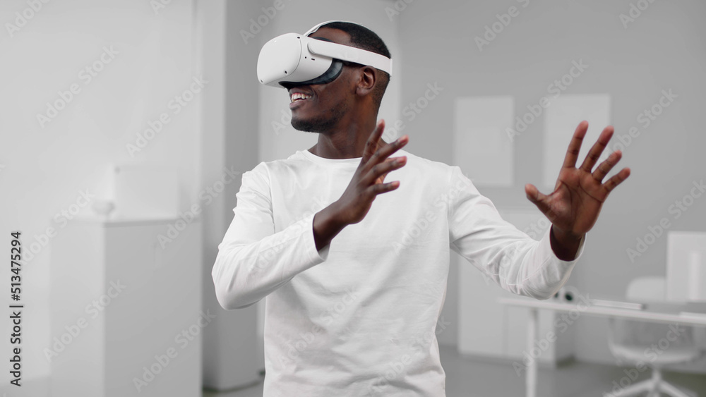 Portrait of African-American man in white clothes use augmented reality headset Portrait of African-American man in white clothes use augmented reality headset