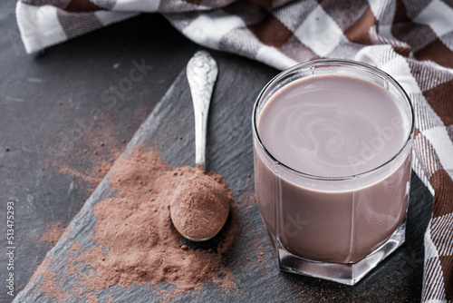 chocolate cocoa milk powder on a black stone background