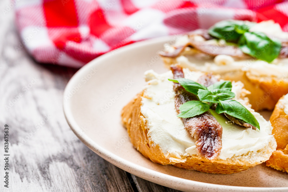 sandwich with anchovy fillet on a tray for serving on a wooden rustic background sandwich with anchovy fillet on a tray for serving on a wooden rustic background