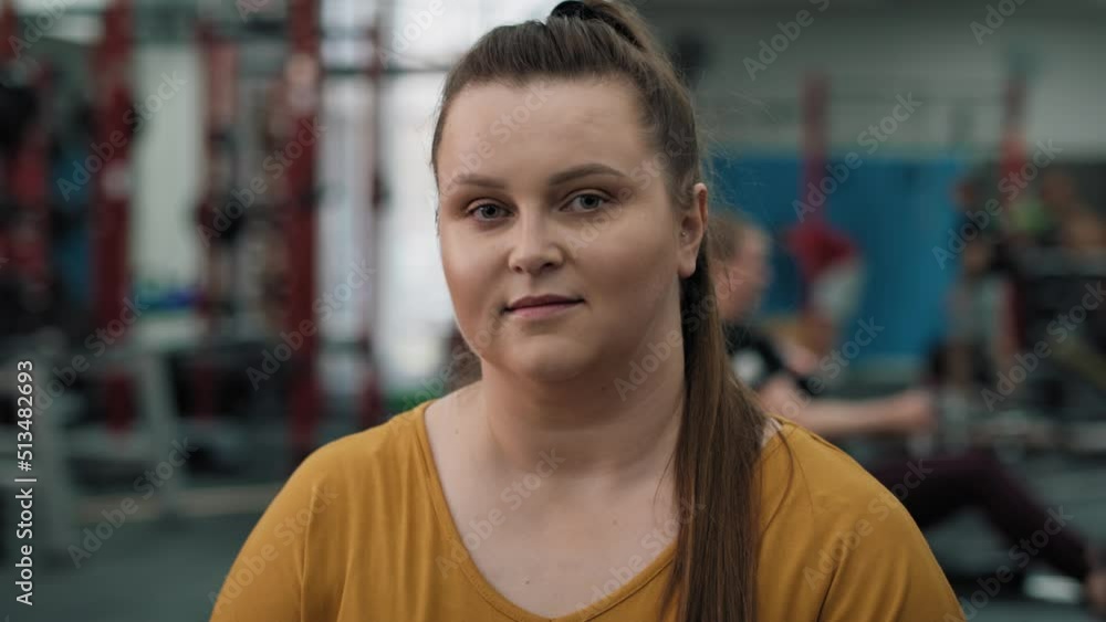 Portrait of smiling caucasian woman with overweight at the gym. Shot with RED helium camera in 4K. Portrait of smiling caucasian woman with overweight at the gym. Shot with RED helium camera in 4K.