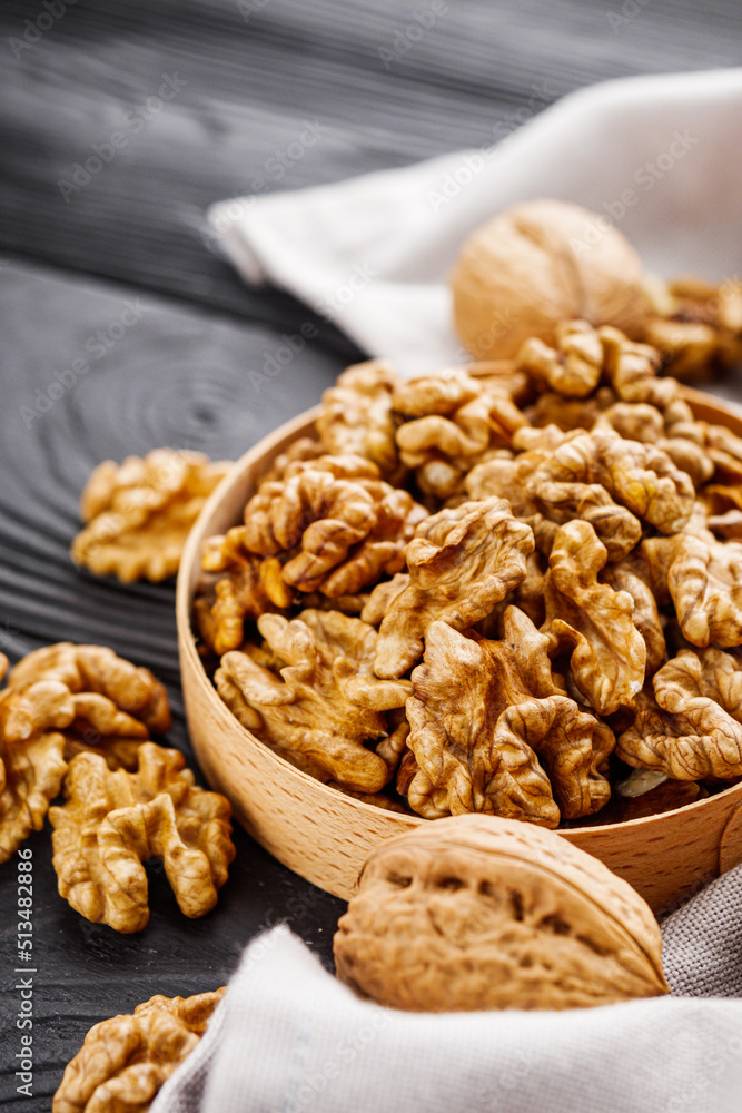 dried walnuts on a black rustic wooden background dried walnuts on a black rustic wooden background