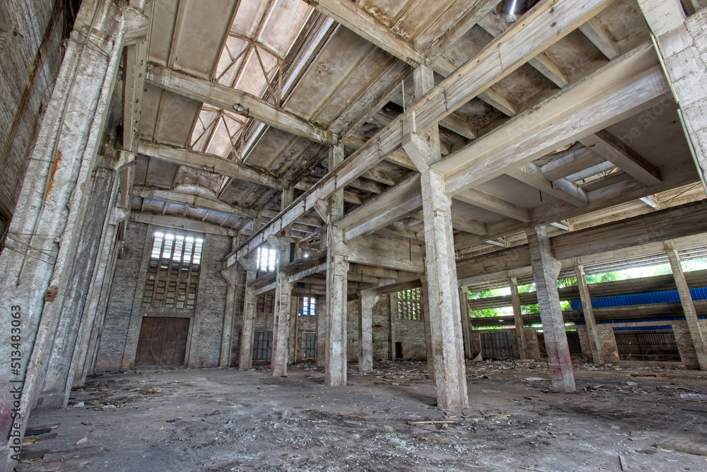 Interior of abandoned steel frame workshop factory building in industrial area Interior of abandoned steel frame workshop factory building in industrial area