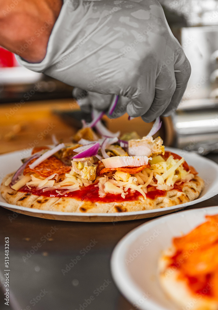 hand of chef baker making mini pizza at kitchen. The process of making pita pizza. cooking italian pizza