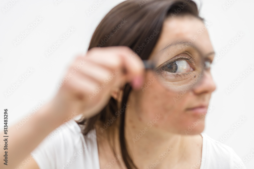 Close up photo of woman with dry skin with magnifying glass. Close up photo of woman with dry skin with magnifying glass.