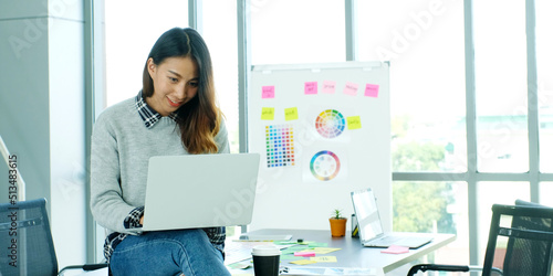 Young asian woman concentrate on working with laptop computer at office, Asian office woman comtemplate on laptop, Asia female business people and office lifestyle concept photo