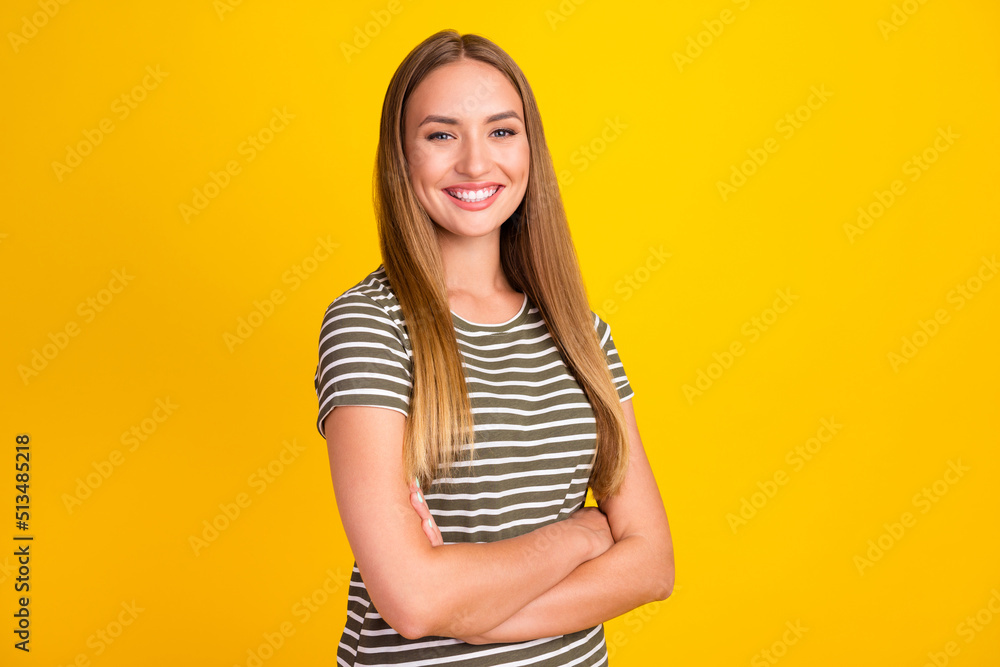 Portrait of half turned cheerful successful lady folded arms beaming smile isolated on yellow color background Portrait of half turned cheerful successful lady folded arms beaming smile isolated on yellow color background