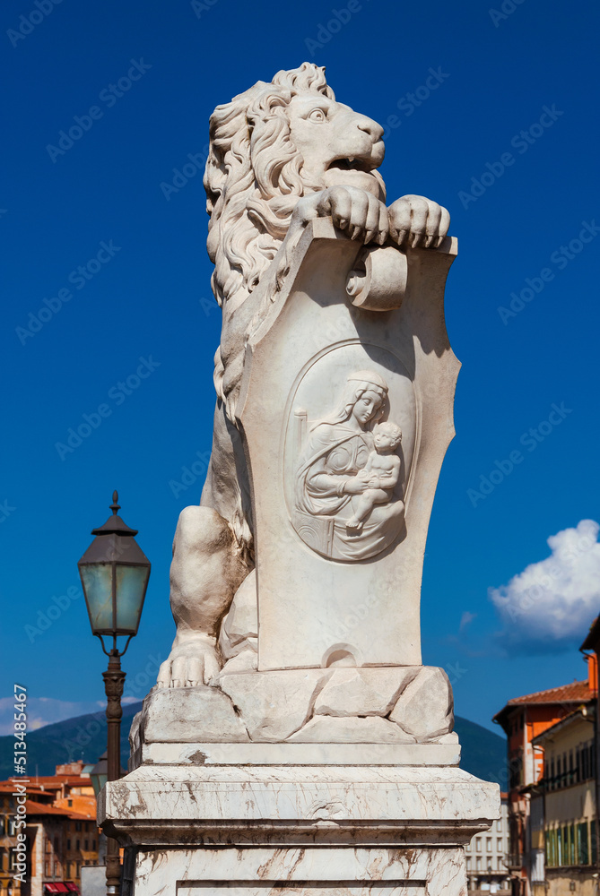 Marble lion statue with old streetlamp, erected in 1875 in Pisa historical center