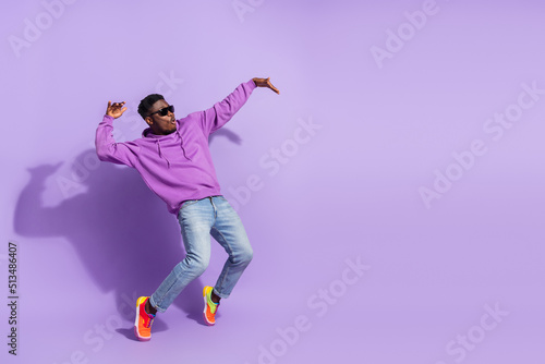 Fototapeta Naklejka Na Ścianę i Meble -  Full length profile photo of overjoyed carefree person stand tip toe dancing isolated on purple color background
