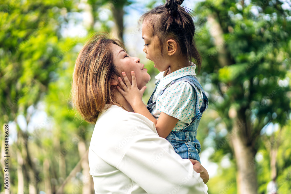 Portrait of happy love asian grandmother and little asian cute girl enjoy relax in summer park.Young girl with their laughing grandparent smiling together.Family and togetherness Portrait of happy love asian grandmother and little asian cute girl enjoy relax in summer park.Young girl with their laughing grandparent smiling together.Family and togetherness