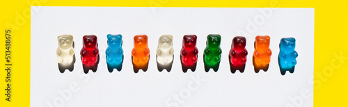Top view of line from jelly bears on white and yellow, banner. © LIGHTFIELD STUDIOS