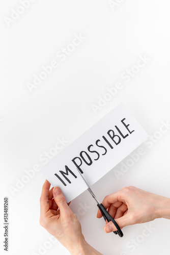 Plakat Hands changing word impossible to possible with scissors. Selfmade concept
