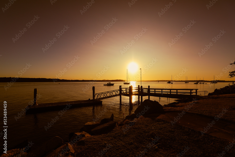 Vibrant afternoon sunset over jetty at Iluka, NSW Australia