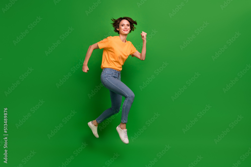 Full length profile photo of sportive charming person running jump isolated on green color background Full length profile photo of sportive charming person running jump isolated on green color background