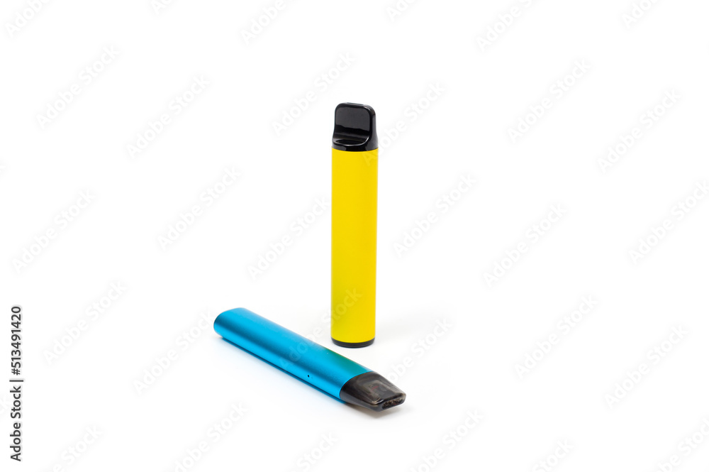 Two electronic cigarettes disposable and refillable with a replaceable cartridge in a blue and yellow body, photographed against a white background Two electronic cigarettes disposable and refillable with a replaceable cartridge in a blue and yellow body, photographed against a white background