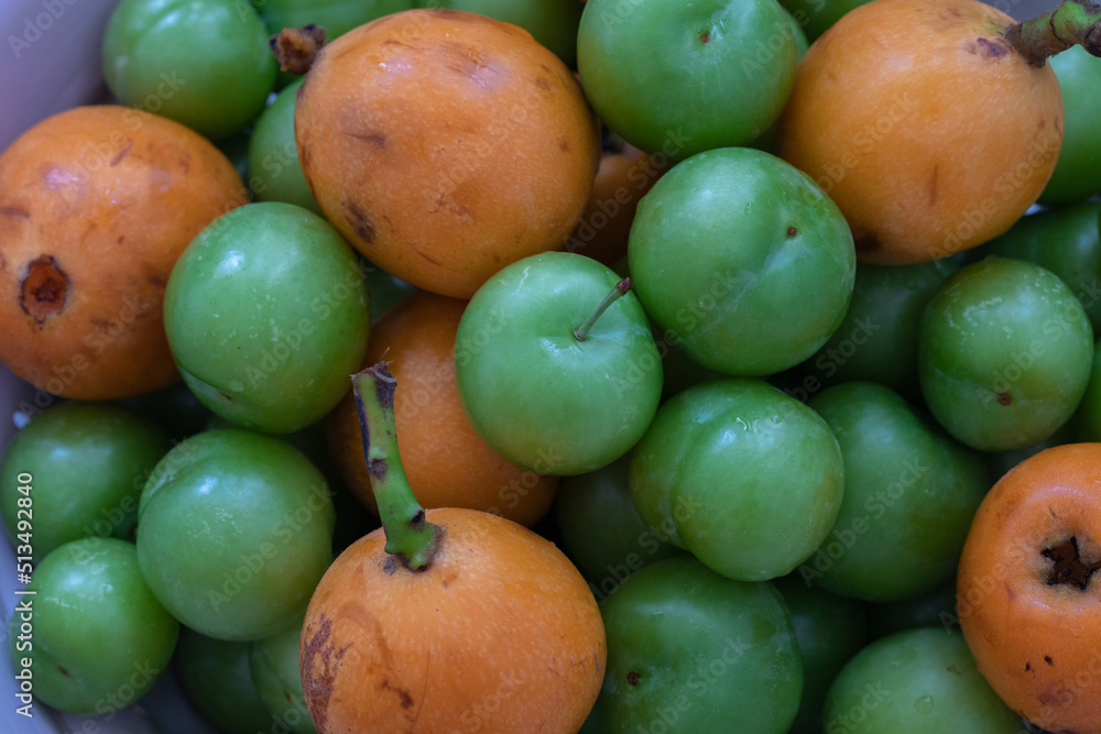 fresh loquat and plum fruit in the market