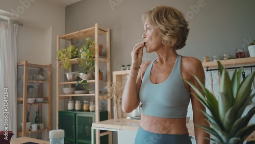 Beautiful senior woman preparing an healthy breakfast with fresh fruits early in the morning
