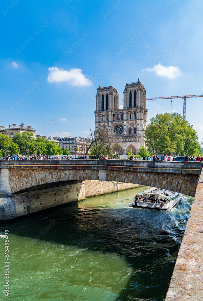 Paris, France - April 24, 2022: view of Notre Dame Cathedral from a bank of the Seine River