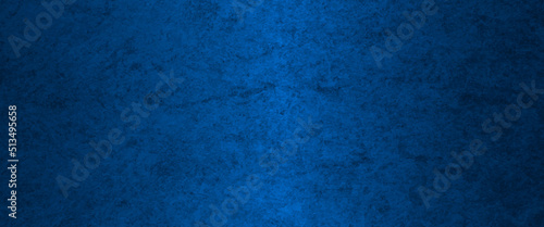 Blue abstract lava stone texture background, dark blue rough grainy stone or concrete wall texture background, Blue background with faint texture and bright center and black vignette border.
