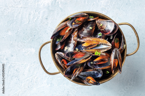 Mussels in a copper bowl, shot from above with copy space, on a slate background
