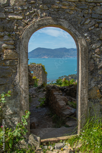 doorway in stone antique wall overlooking the sea