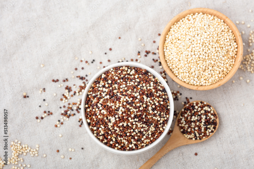 Red ,white and black quinoa in bowls with spoon on table Red ,white and black quinoa in bowls with spoon on table