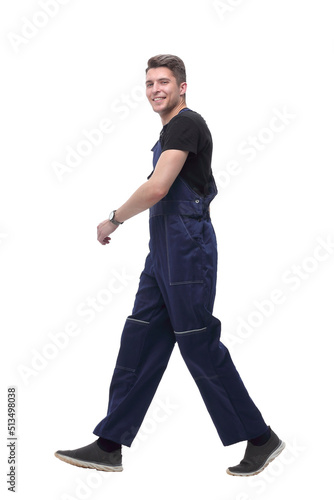 smiling man in overalls goes forward.isolated on white
