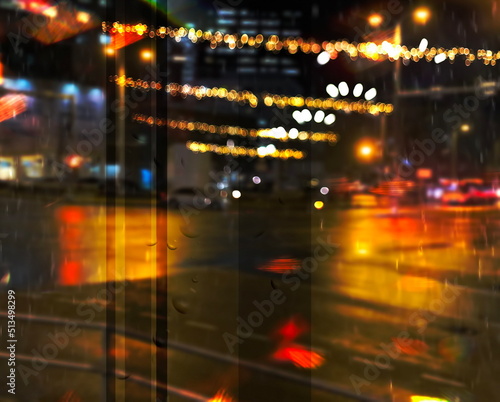 city night light street reflection car traffic buildings blurred light red yellow bokeh vew from window urban holiday lifestyle
