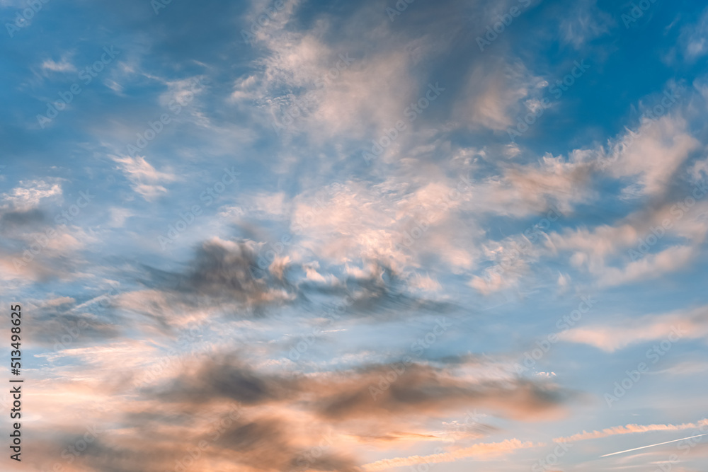 Natural background: dramatic colourful sky at sunset. Pink and blue colours of sunset sky. Abstract blurred clouds.