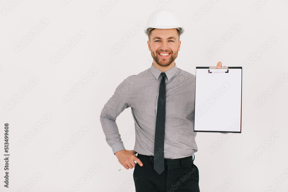 Happy male chief architect holding a folder with copy space and showing something on a white background Happy male chief architect holding a folder with copy space and showing something on a white background
