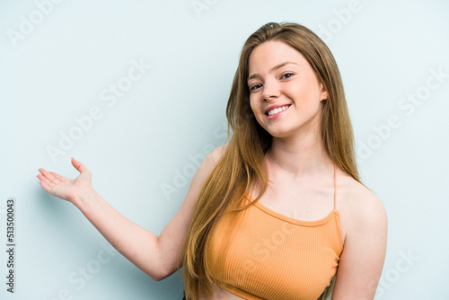 Wallpaper Mural Young caucasian woman isolated on blue background showing a welcome expression. Torontodigital.ca