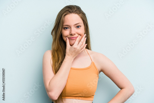 Young caucasian woman isolated on blue background doubting between two options. © Asier