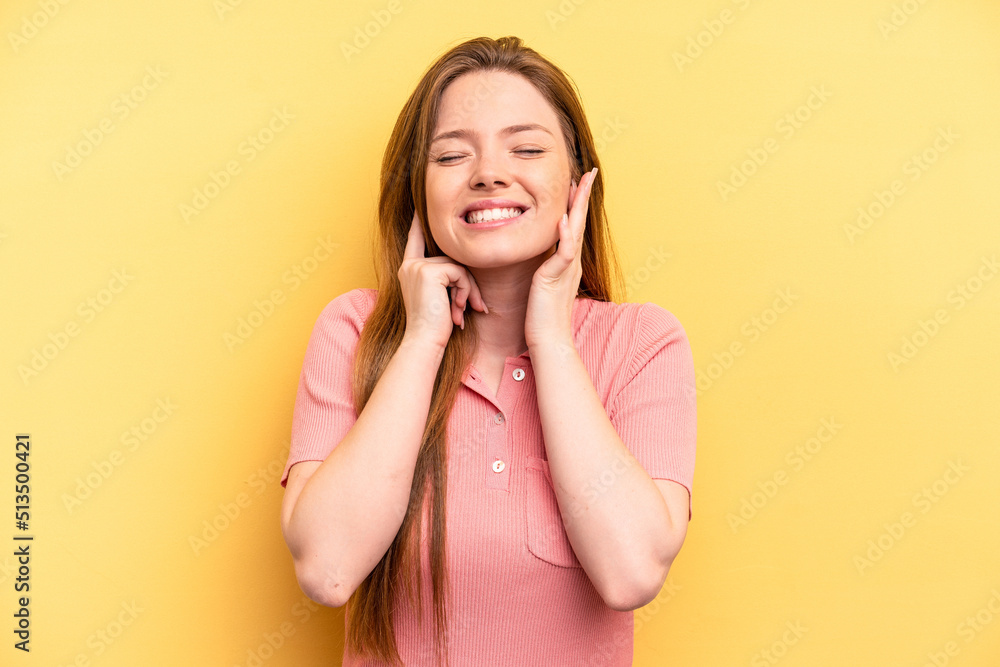 Young caucasian woman isolated on yellow background covering ears with hands. Young caucasian woman isolated on yellow background covering ears with hands.