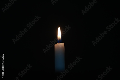 candle in the dark, black background